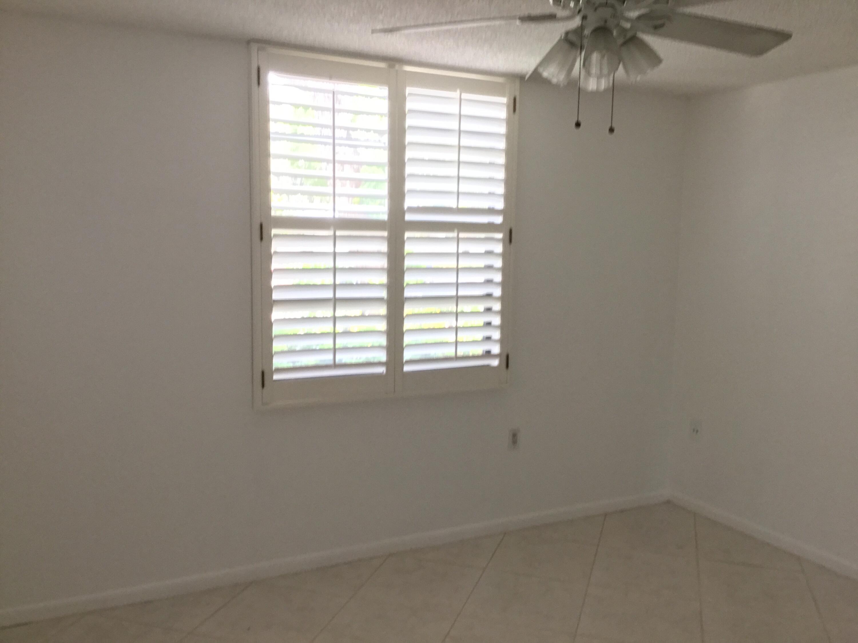 3636 Whitehall Drive, Unit 101 West Palm Beach, FL 33401 - Photo 13 of 16 an empty room with a window