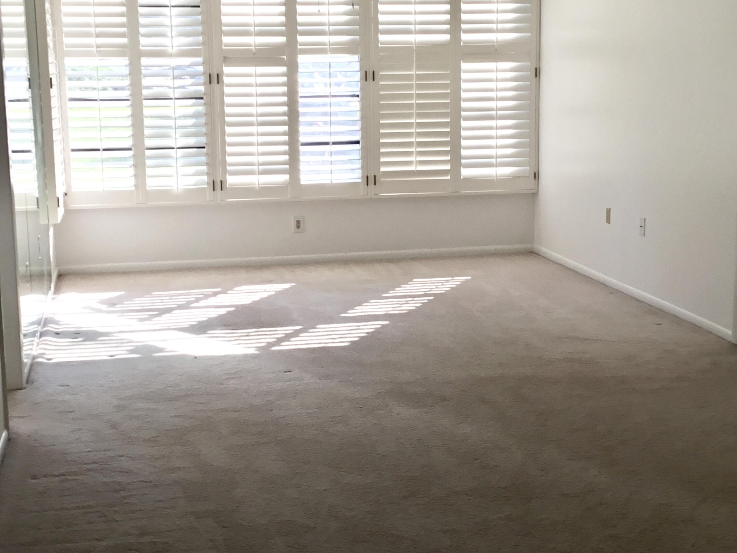 3636 Whitehall Drive, Unit 101 West Palm Beach, FL 33401 - Photo 6 of 16 a view of an empty room with a window
