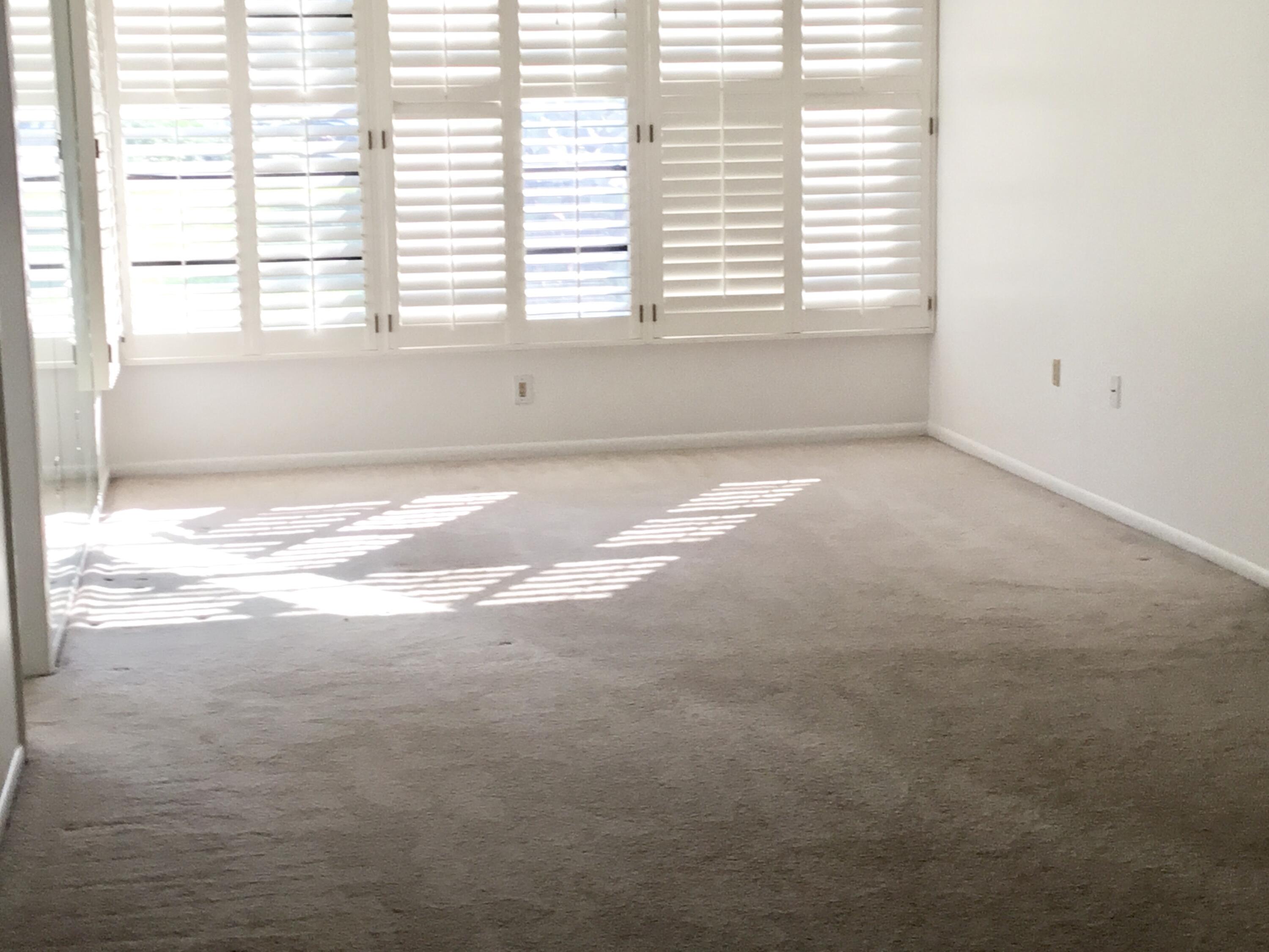 3636 Whitehall Drive, Unit 101 West Palm Beach, FL 33401 - Photo 7 of 16 a view of an empty room with a window