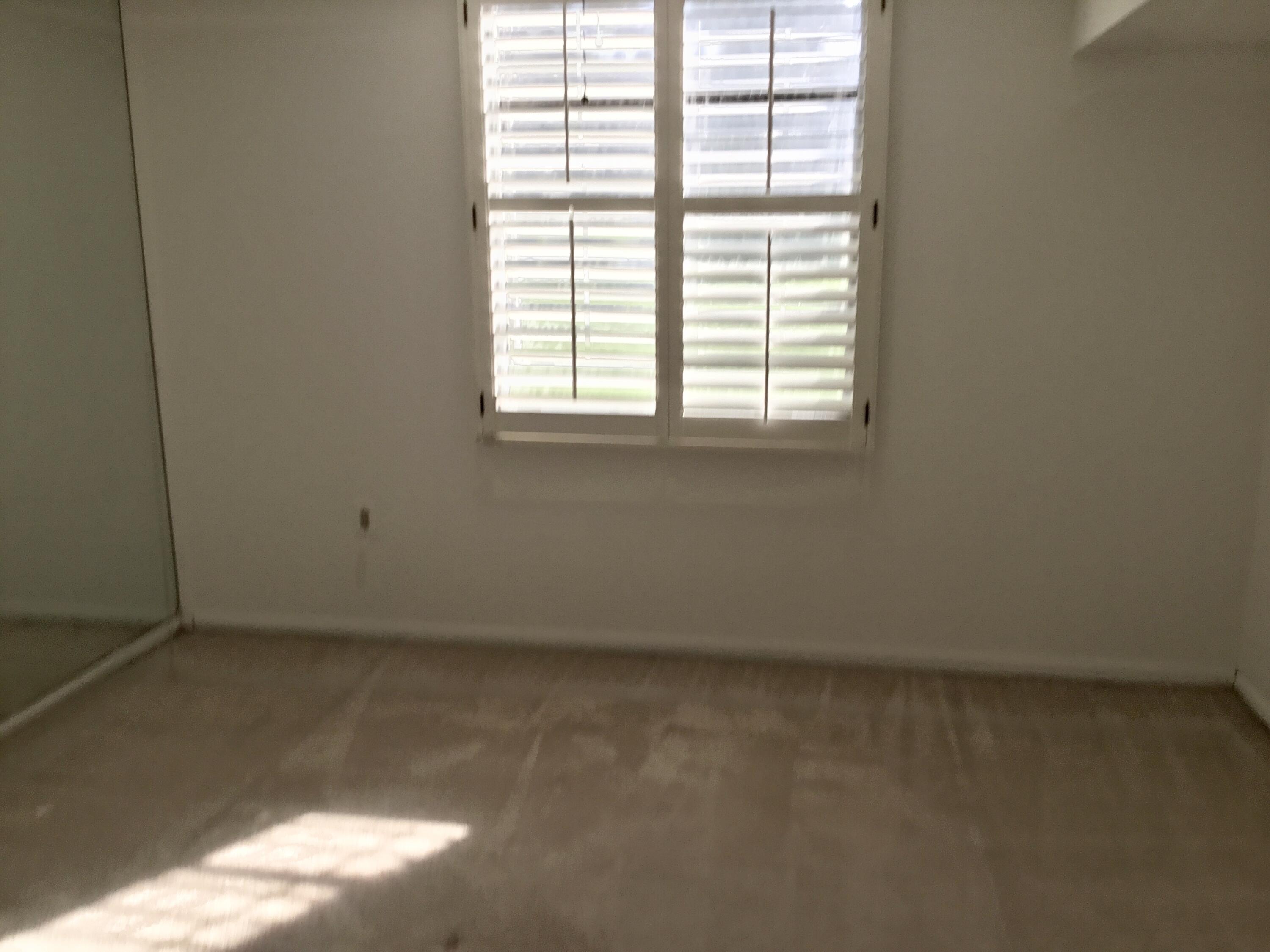 3636 Whitehall Drive, Unit 101 West Palm Beach, FL 33401 - Photo 8 of 16 an empty room with a window