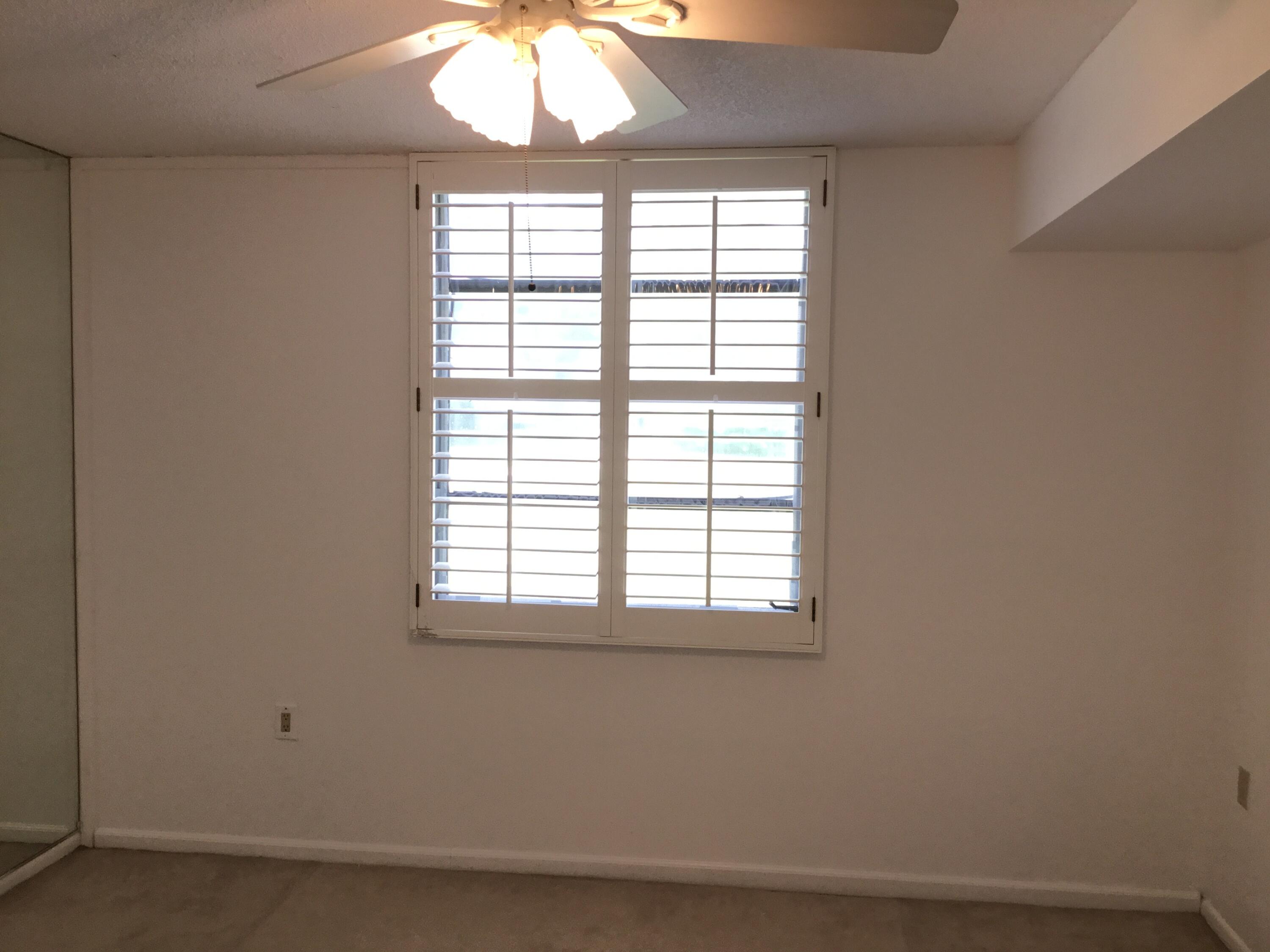 3636 Whitehall Drive, Unit 101 West Palm Beach, FL 33401 - Photo 9 of 16 an empty room with a window