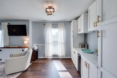 a kitchen with white cabinets and black stainless steel appliances