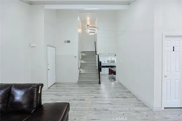 a view of entryway and hall with wooden floor