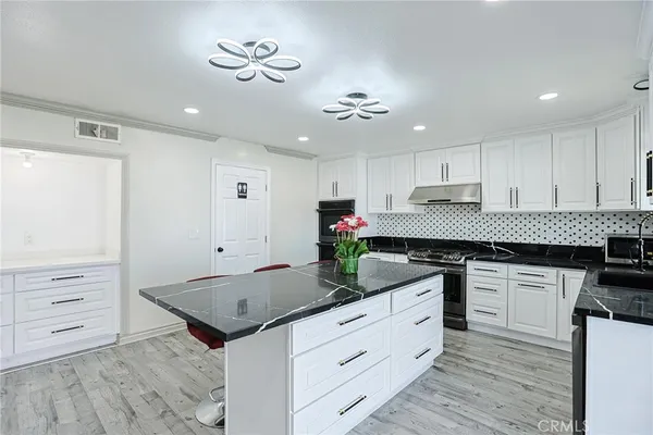 a kitchen with a stove a sink and a refrigerator