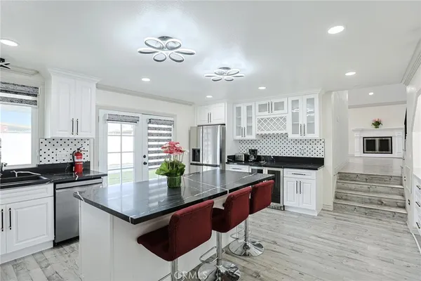 a kitchen with stainless steel appliances granite countertop a sink and stove