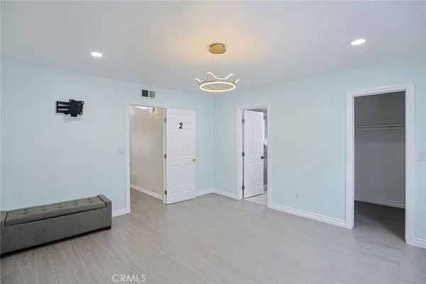 a bathroom with a granite countertop sink toilet and a mirror
