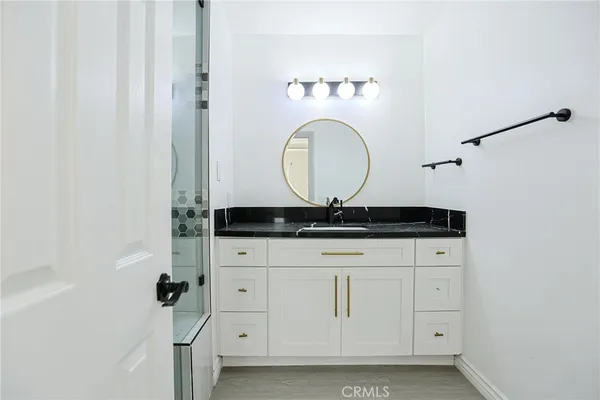 a bathroom with a granite countertop sink mirror and vanity