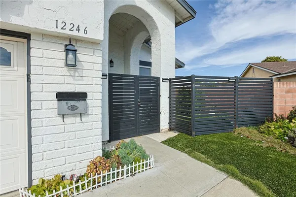 a view of a brick house with a small yard
