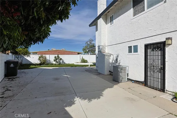 a view of a house with a yard and sitting area