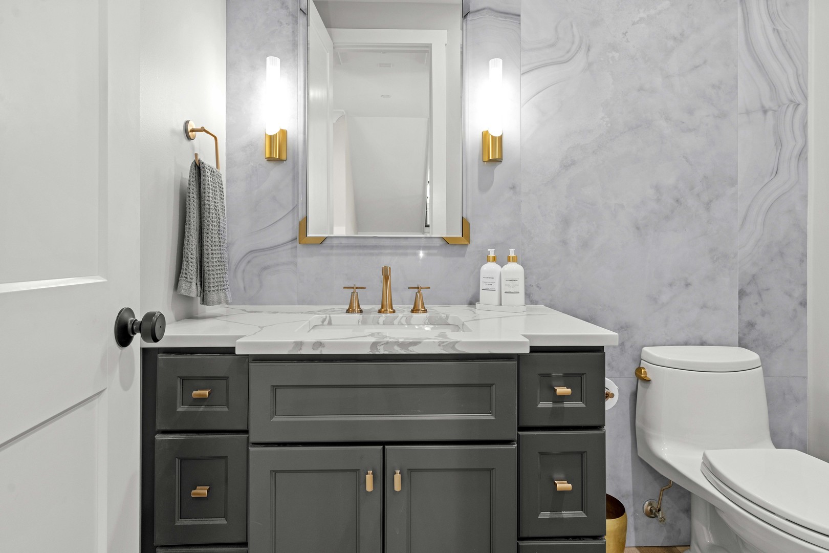 1318 Kenton Road Deerfield, IL 60015 - Photo 21 of 56 a bathroom with a granite countertop toilet sink and mirror