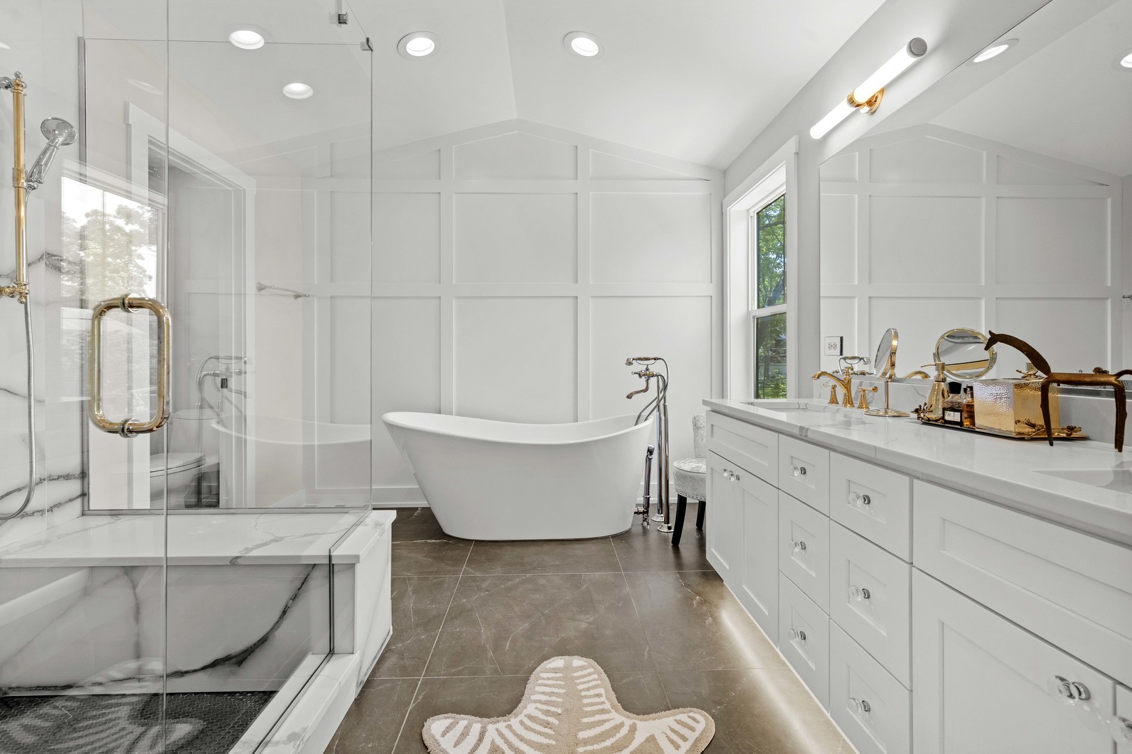 1318 Kenton Road Deerfield, IL 60015 - Photo 28 of 56 a bathroom with a bathtub sink and mirror