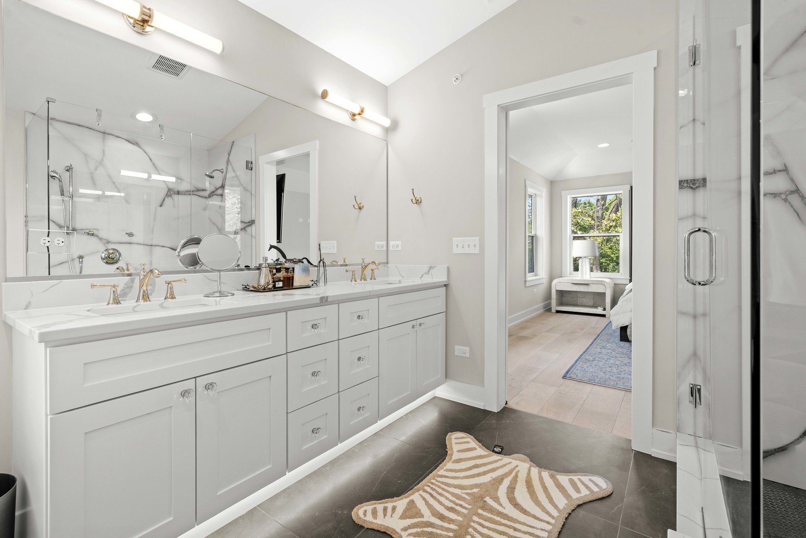 1318 Kenton Road Deerfield, IL 60015 - Photo 29 of 56 a spacious bathroom with a double vanity sink a mirror a bathtub and shower