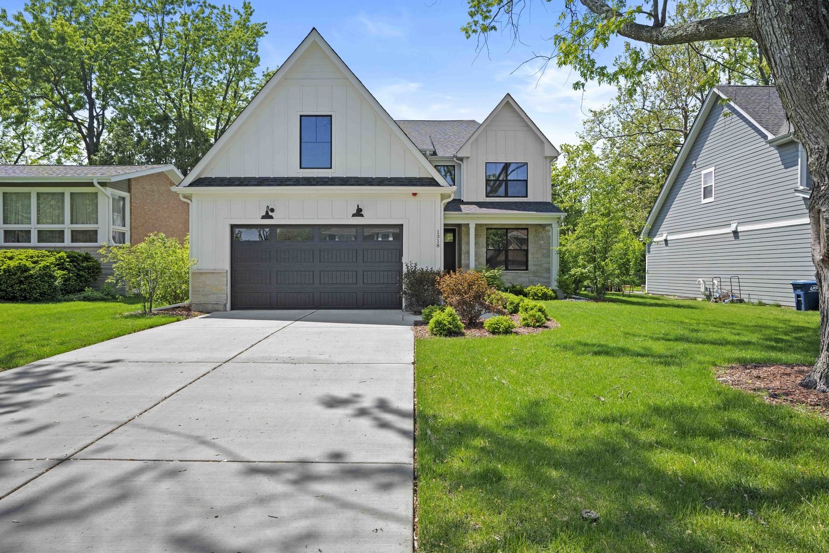 1318 Kenton Road Deerfield, IL 60015 - Photo 3 of 56 a front view of a house with a yard and garage