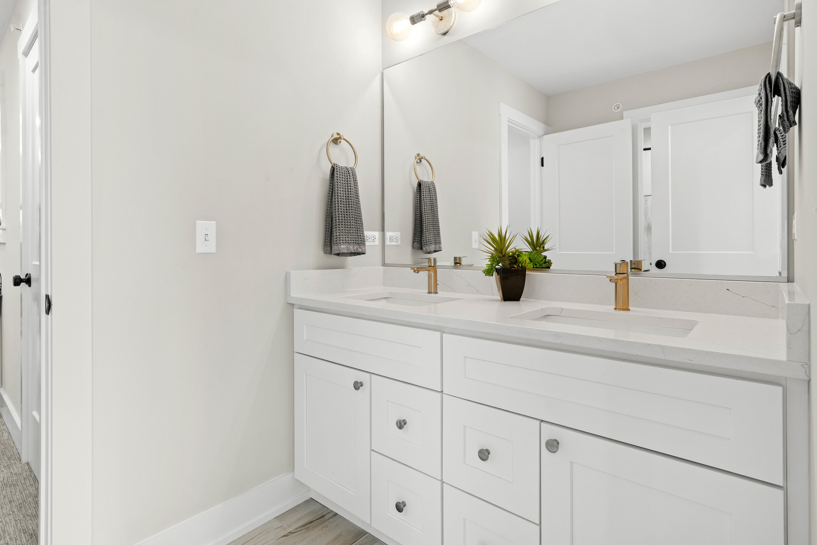1318 Kenton Road Deerfield, IL 60015 - Photo 34 of 56 a bathroom with a sink and a mirror