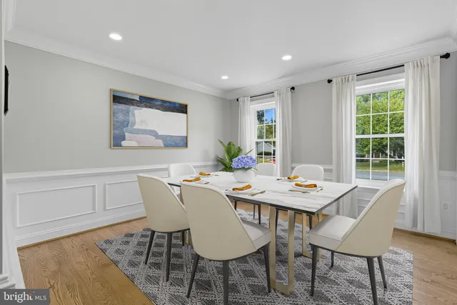 a large white kitchen with a large counter top and stainless steel appliances