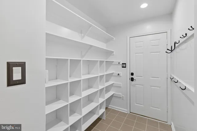 a kitchen with stainless steel appliances kitchen island granite countertop a table chairs sink and cabinets