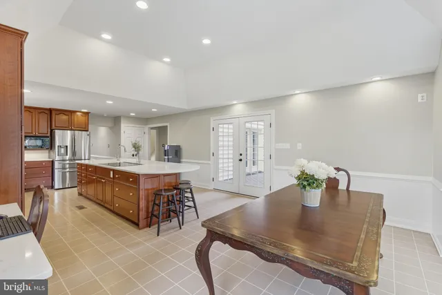 a kitchen with stainless steel appliances granite countertop a sink and a refrigerator