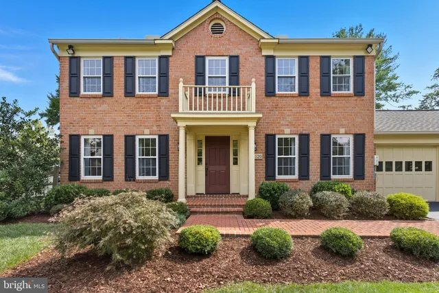 front view of a brick house with a yard