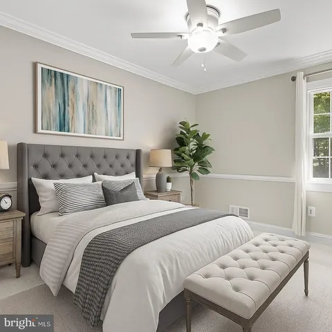 a bedroom with a bed and a potted plant