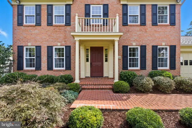 a view of a hallway with wooden floor and entryway