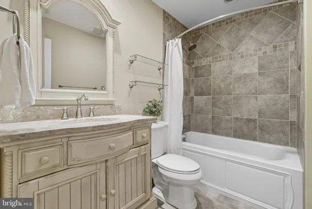 a front view of a house with a garden and trees