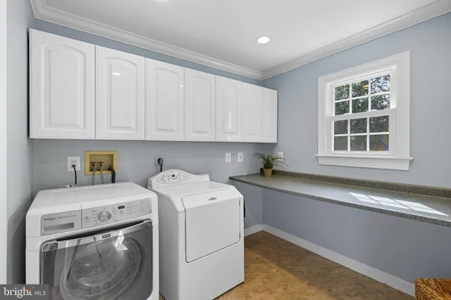 a view of a house with a big yard and large trees