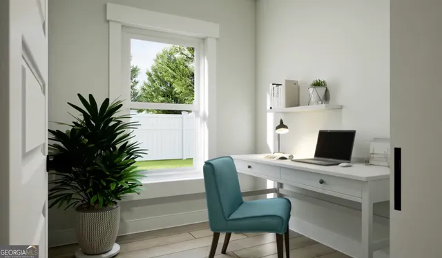 a view of a workspace with furniture and a potted plant