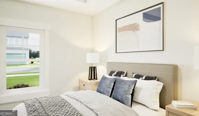 a bedroom with a bed and a painting on the wall