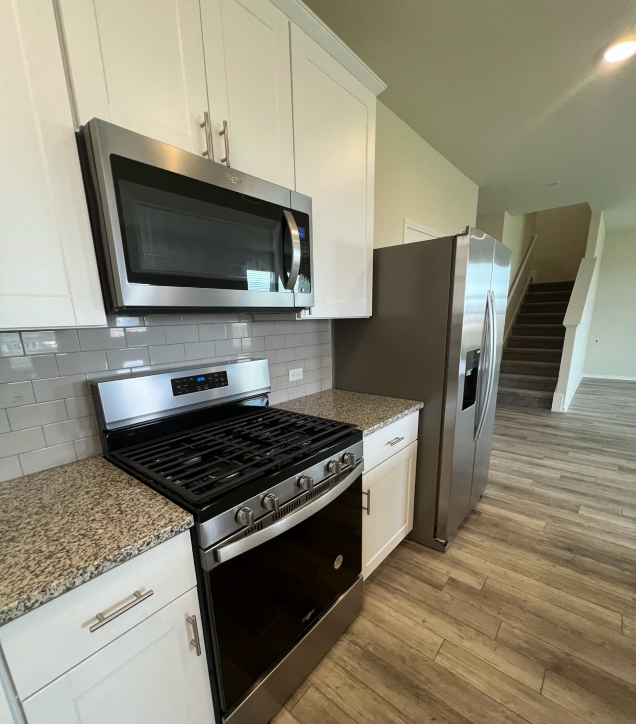 499 Tree Nut Loop Buda, TX 78610 - Photo 8 of 33 The contemporary kitchen features stainless steel appliances, ice maker, and durable granite countertops, offering seamless living.