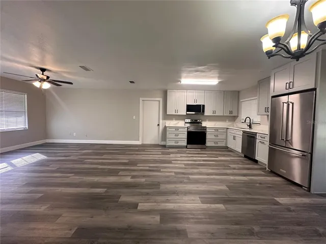 a view of a kitchen with a stove cabinets and wooden floor