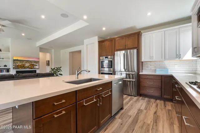 a kitchen with a sink stainless steel appliances and cabinets