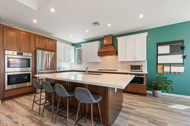 a kitchen with a table chairs microwave and cabinets