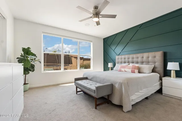a bedroom with a bed couch and window