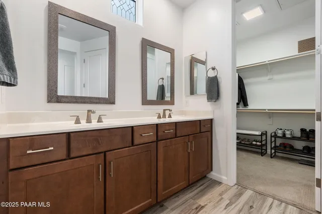 a bathroom with a double vanity sink and a mirror