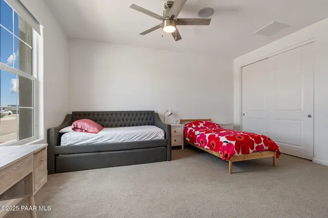 a bedroom with a bed and a couch