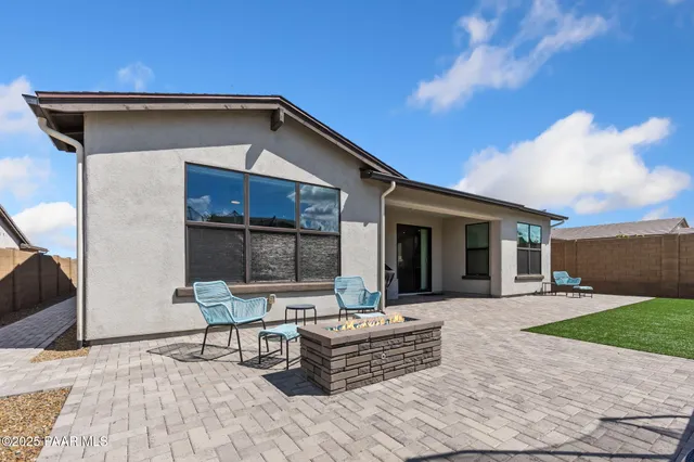 a wooden bench sitting in front of a house