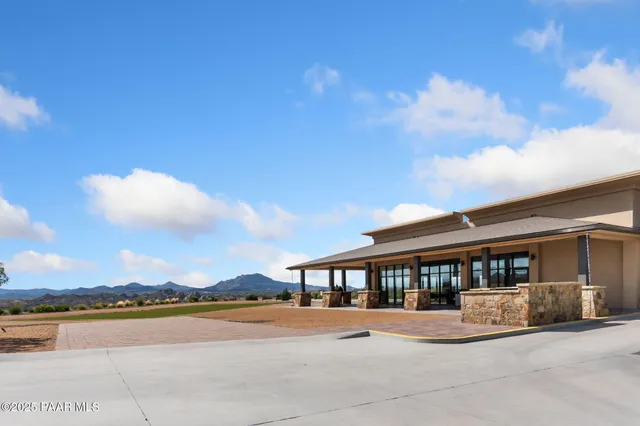 a view of swimming pool with outdoor seating and lake