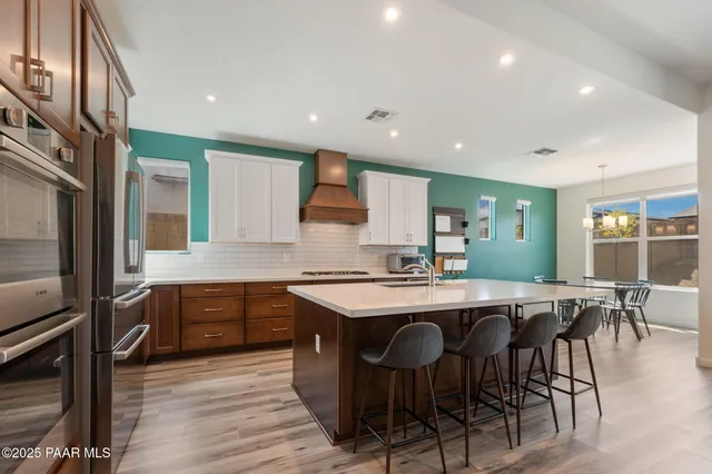 a kitchen with lots of counter top space and painting on the wall
