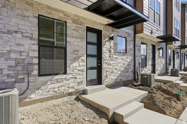 7338 South Seven Tree Lane, Unit 75 Midvale, UT 84047 - Photo 3 of 30 Entrance to property with stone siding and covered porch