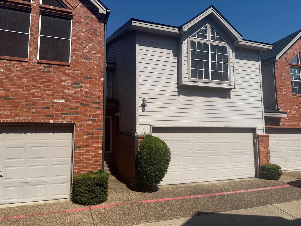 18240 Midway Road, Unit 1204 Dallas, TX 75287 - Photo 2 of 27 a view of a brick house with a large windows