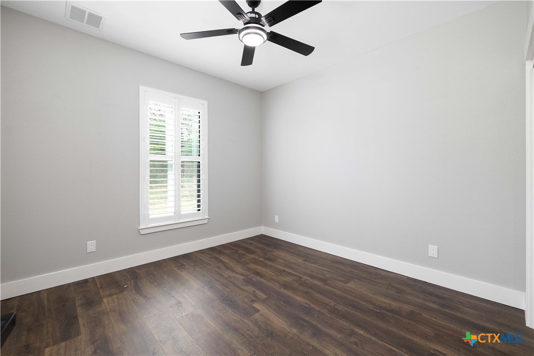 537 Compass Rose Spring Branch, TX 78070 - Photo 22 of 29 an empty room with wooden floor fan and windows