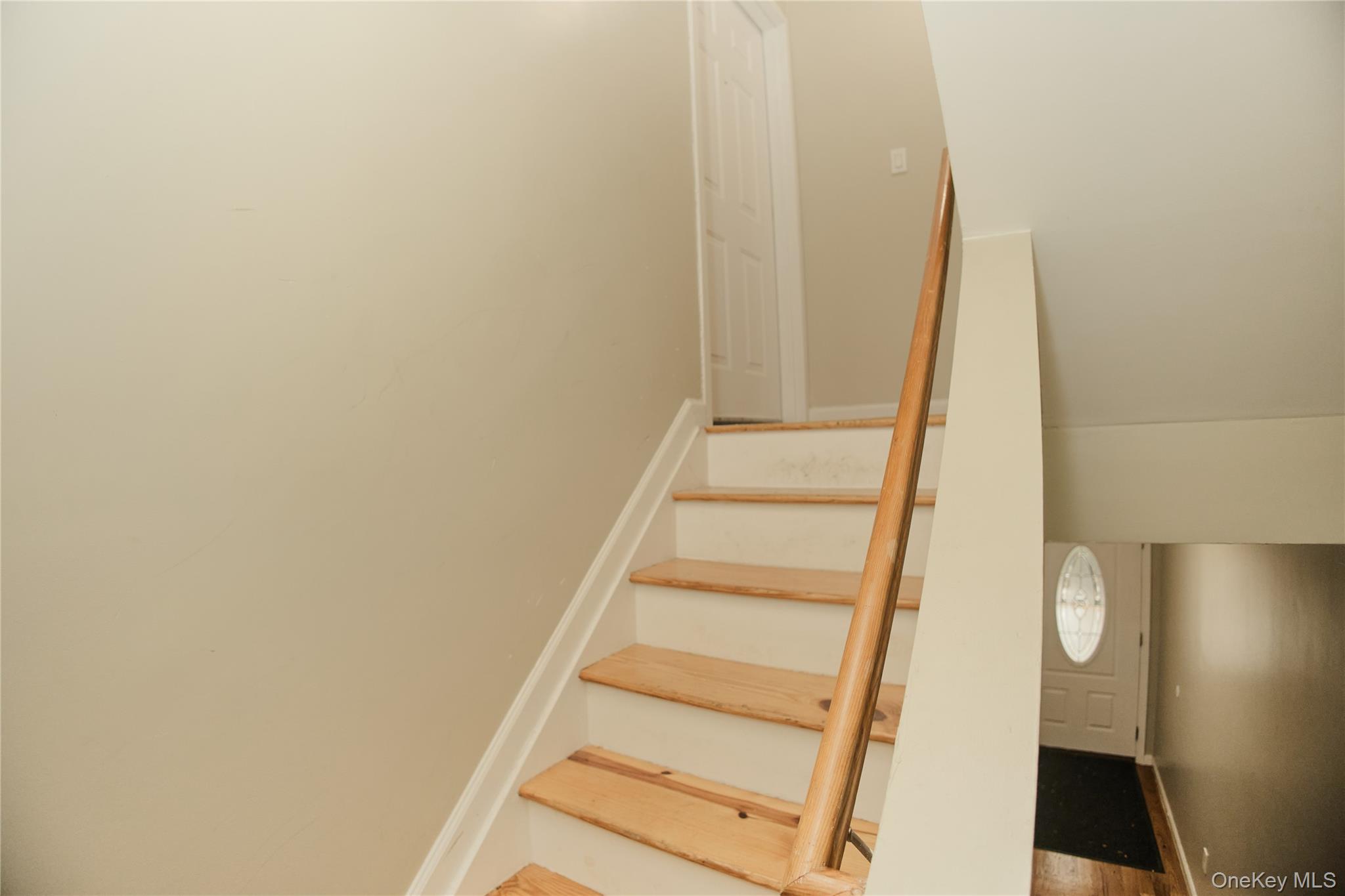1292 Saint Marks Avenue, Unit 2 Brooklyn, NY 11213 - Photo 15 of 32 a view of staircase with white walls and white door