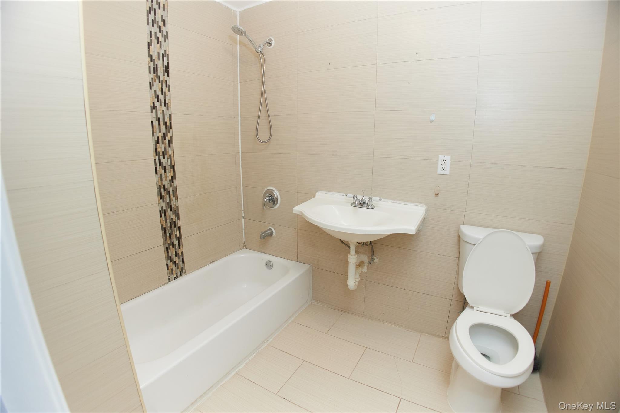 1292 Saint Marks Avenue, Unit 2 Brooklyn, NY 11213 - Photo 22 of 32 a bathroom with a sink a toilet and shower