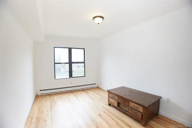 a room with a wooden floor and a window