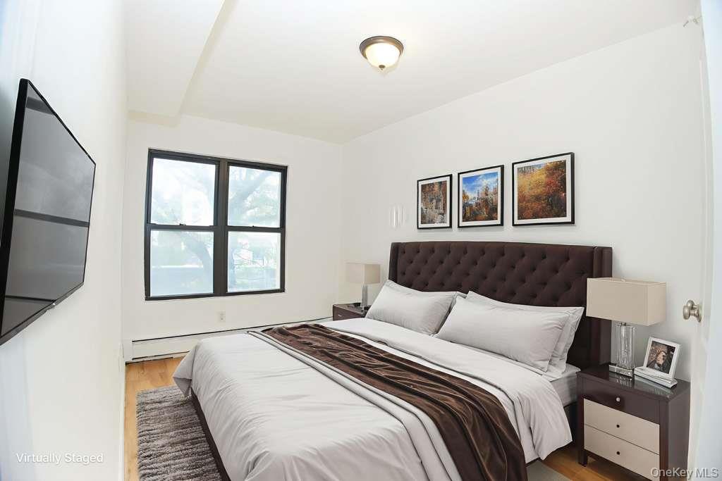 1292 Saint Marks Avenue, Unit 2 Brooklyn, NY 11213 - Photo 5 of 32 a bedroom with a large bed and a window