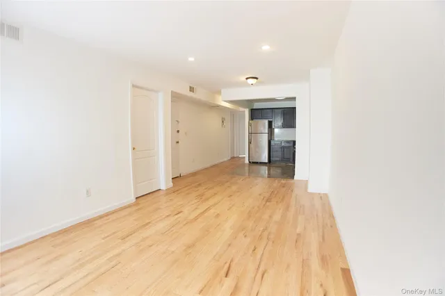 a view of an empty room and wooden floor