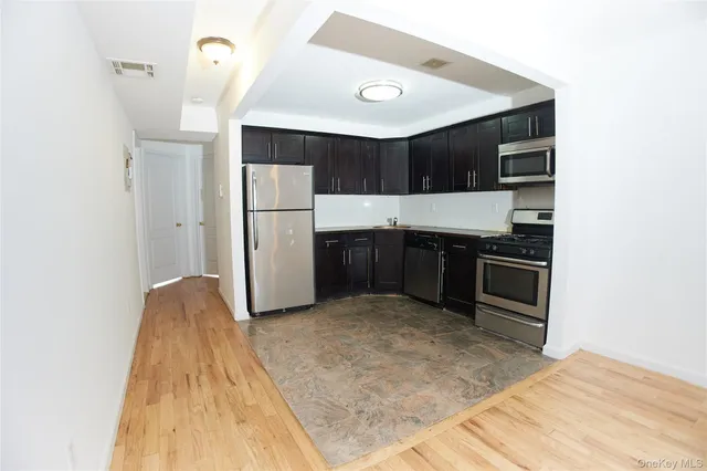 a kitchen with kitchen island a sink and a stove
