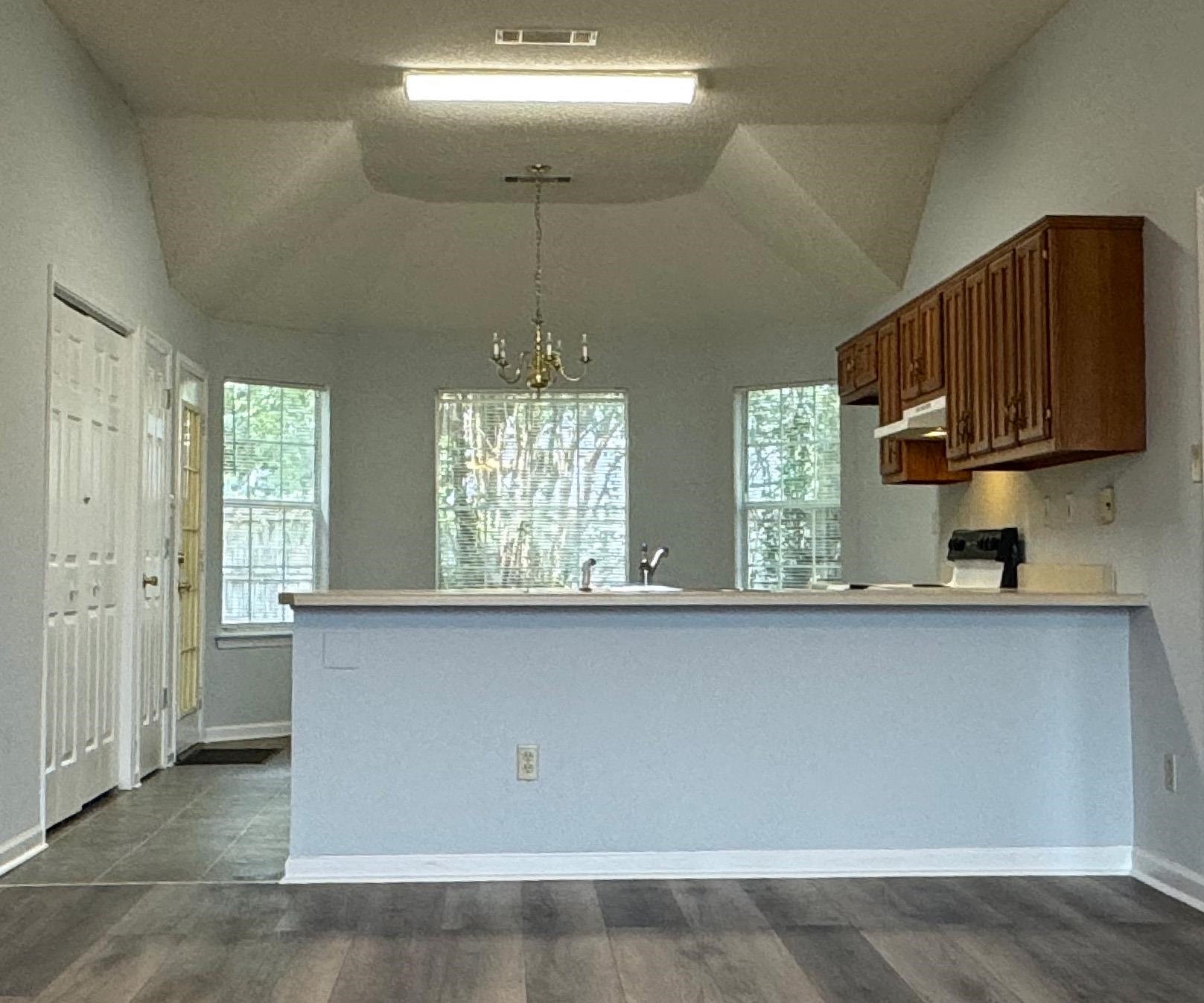 7083 Bryan Station Road Cordova, TN 38018 - Photo 6 of 19 Kitchen with an inviting chandelier, range, vaulted ceiling, and dark hardwood / wood-style floors