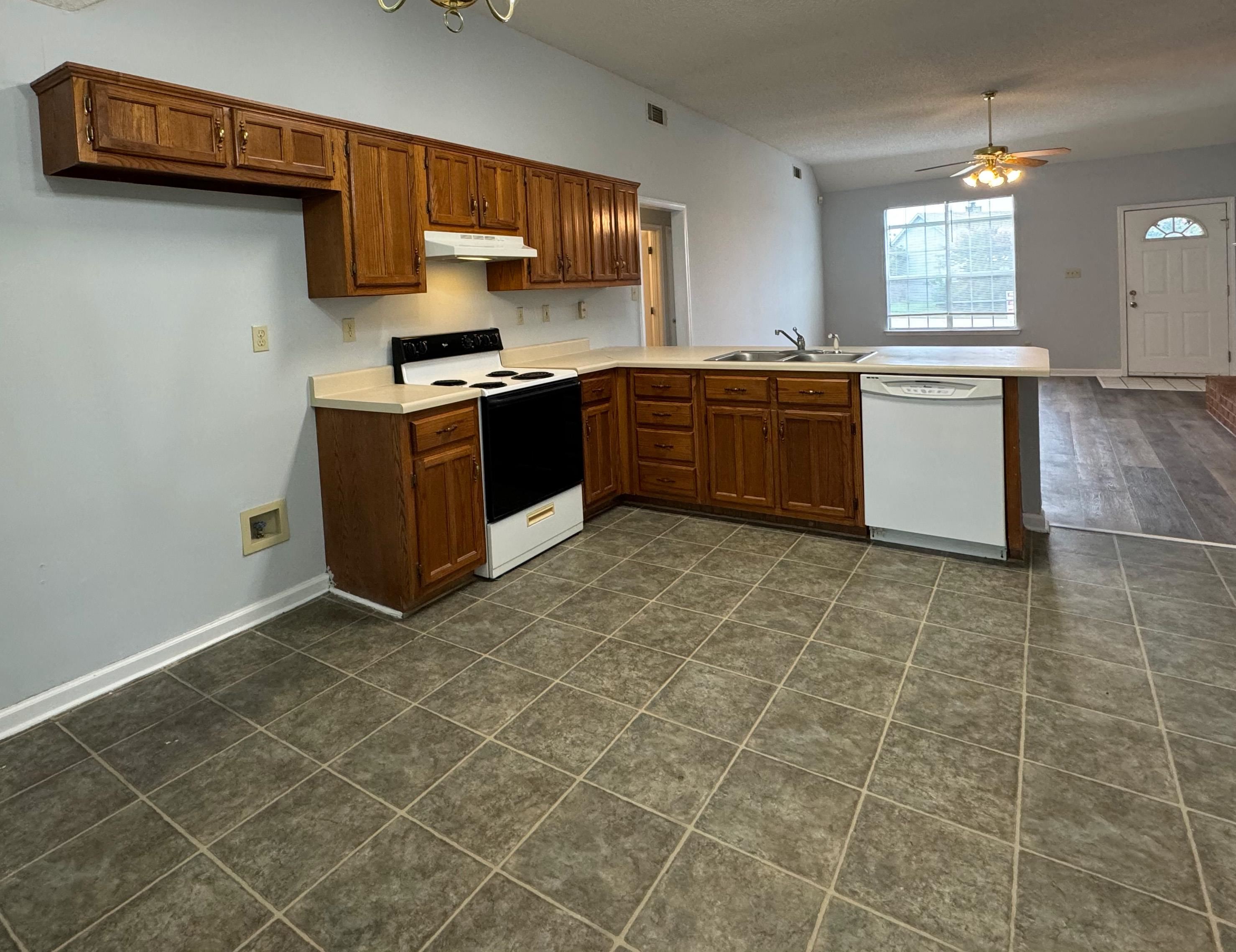 7083 Bryan Station Road Cordova, TN 38018 - Photo 7 of 19 Kitchen featuring white appliances, kitchen peninsula, ceiling fan, dark tile patterned floors, and sink