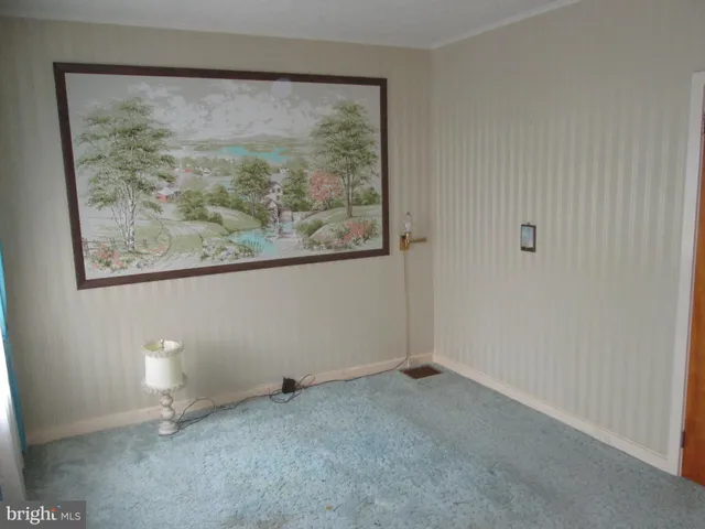 a view of room with window and furniture